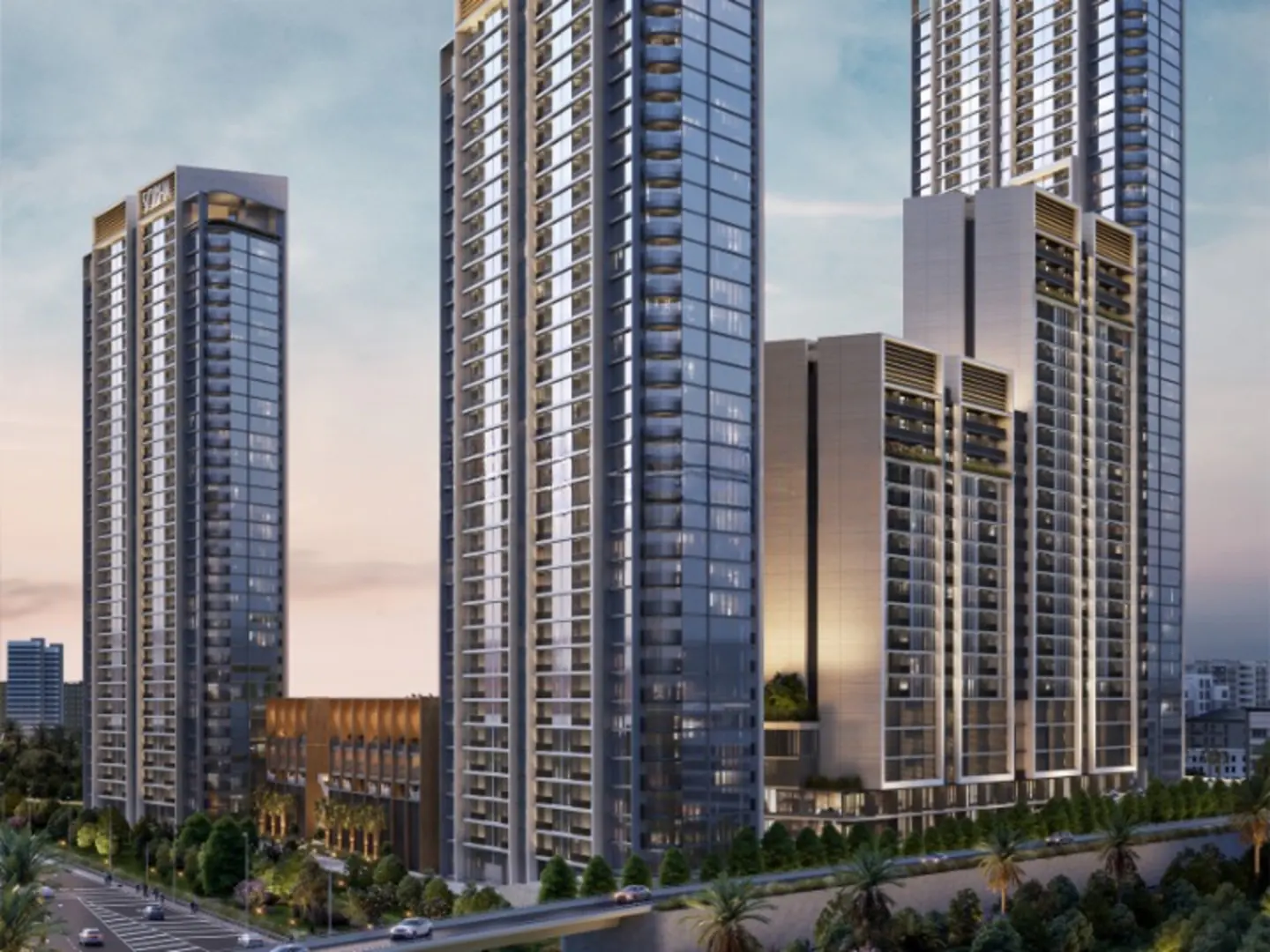 Modern high-rise apartment buildings with glass windows, palm trees, and a road with cars.