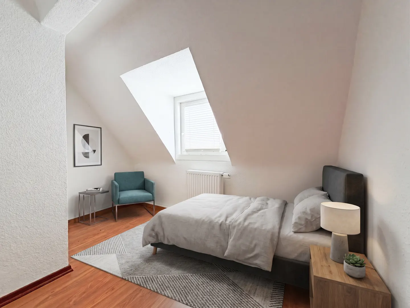 Attic bedroom with white walls, wood floors, and a gray rug. A bed sits under a window, with a blue chair and art on the left.