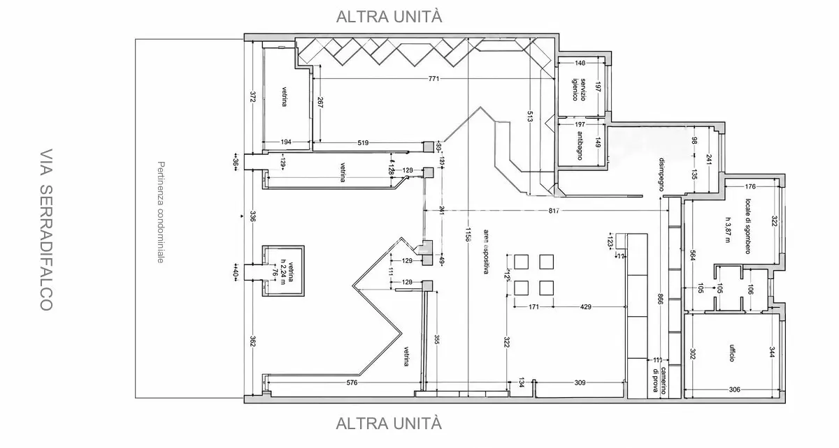 Black and white architectural floor plan of a commercial space with display areas, storage, office, and restroom.