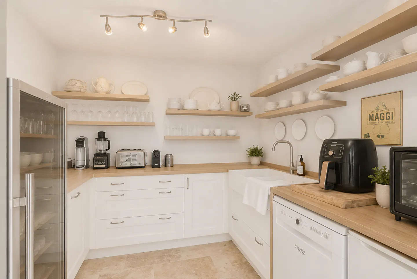 Bright kitchen with white cabinets, wood countertops, and open shelves displaying white dishes. Stainless steel appliances and a wine fridge are visible.
