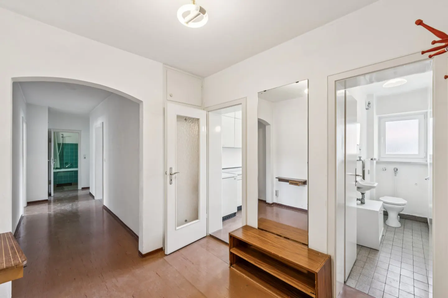 View from the entryway into the central hallway, the two bathrooms, and the entrance to the kitchen