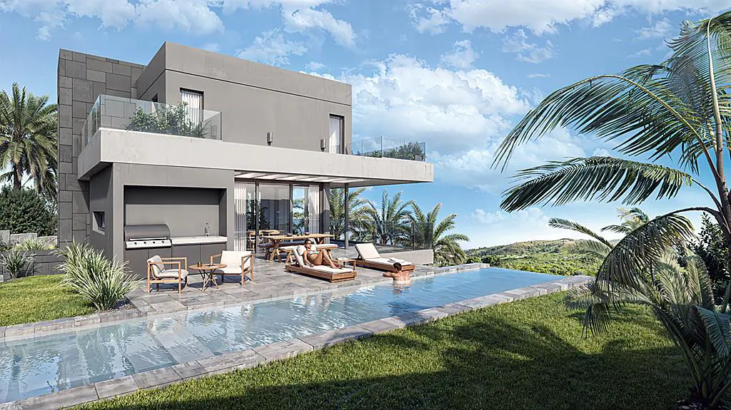 Modern gray house with a pool, lounge chairs, and outdoor kitchen on a sunny day. Palm trees and blue sky in background.