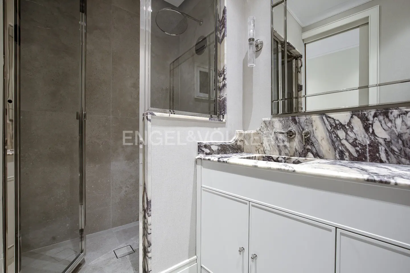 Bathroom with a glass shower, white vanity with a marble countertop, and a mirror above the sink.