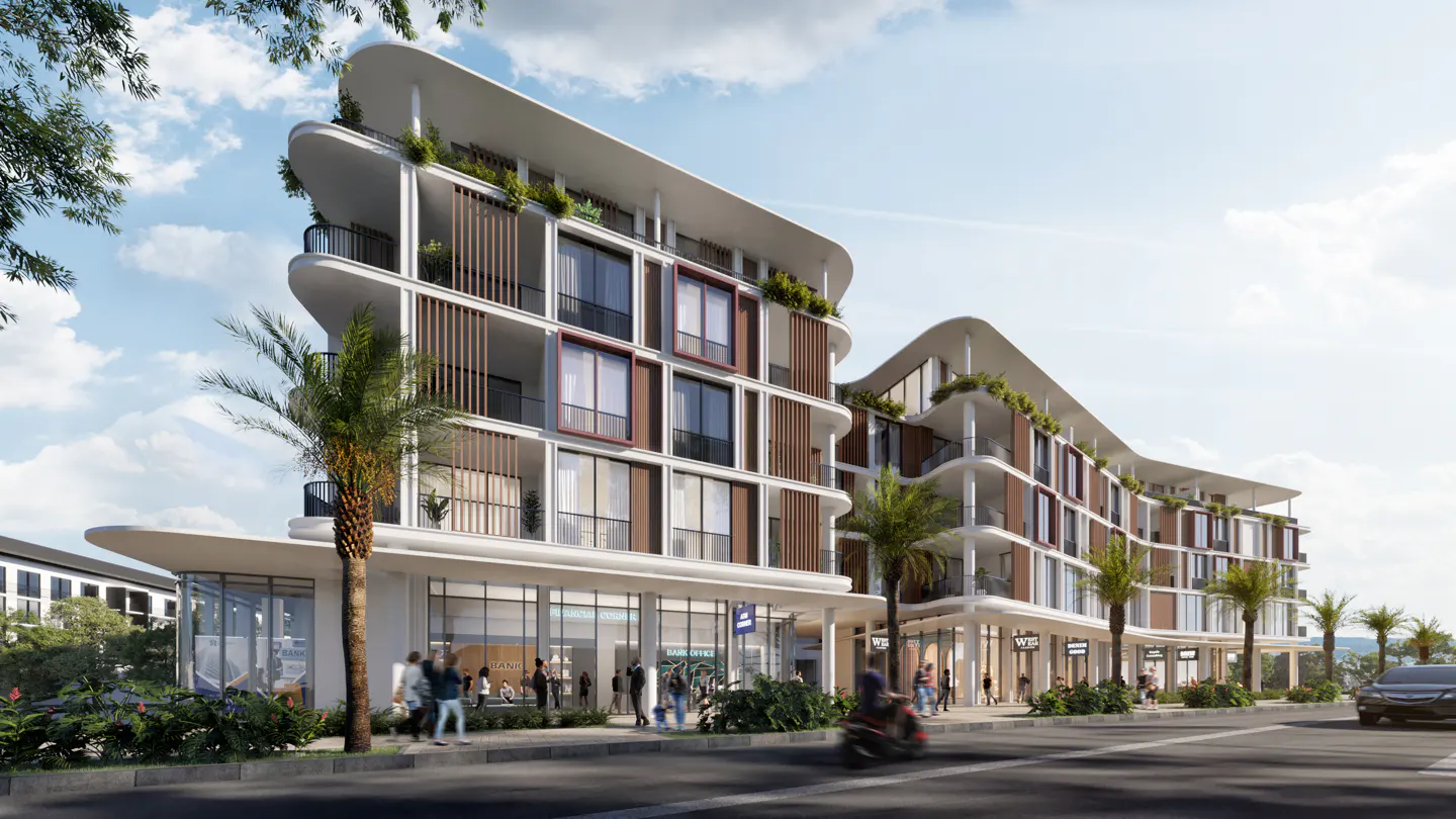 Modern white condo building with curved balconies and retail space on the ground floor, palm trees, blue sky.