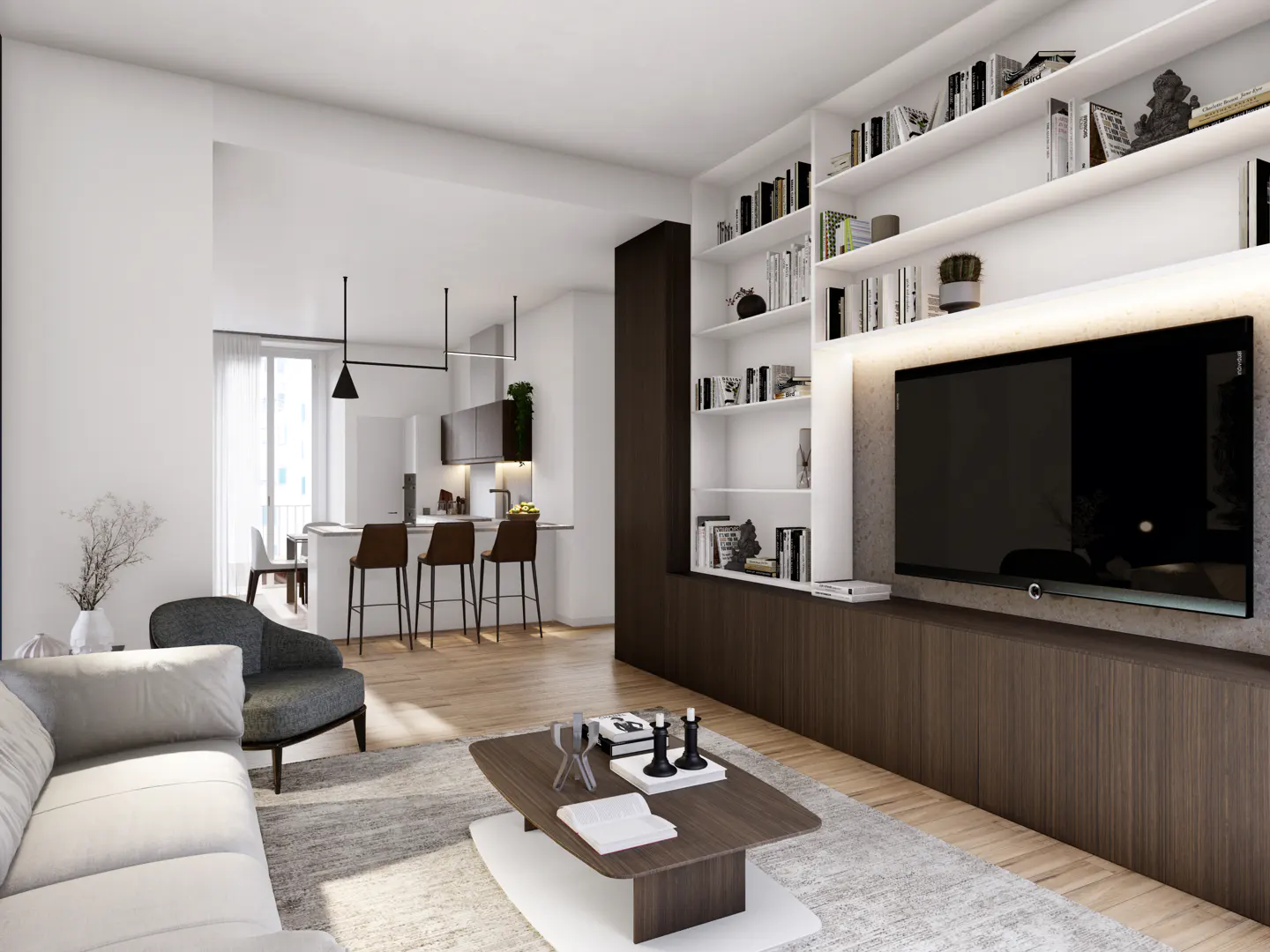 Open-concept living room with white sofa, gray chair, and wood coffee table. Kitchen island with stools in the background. Built-in shelves and TV.