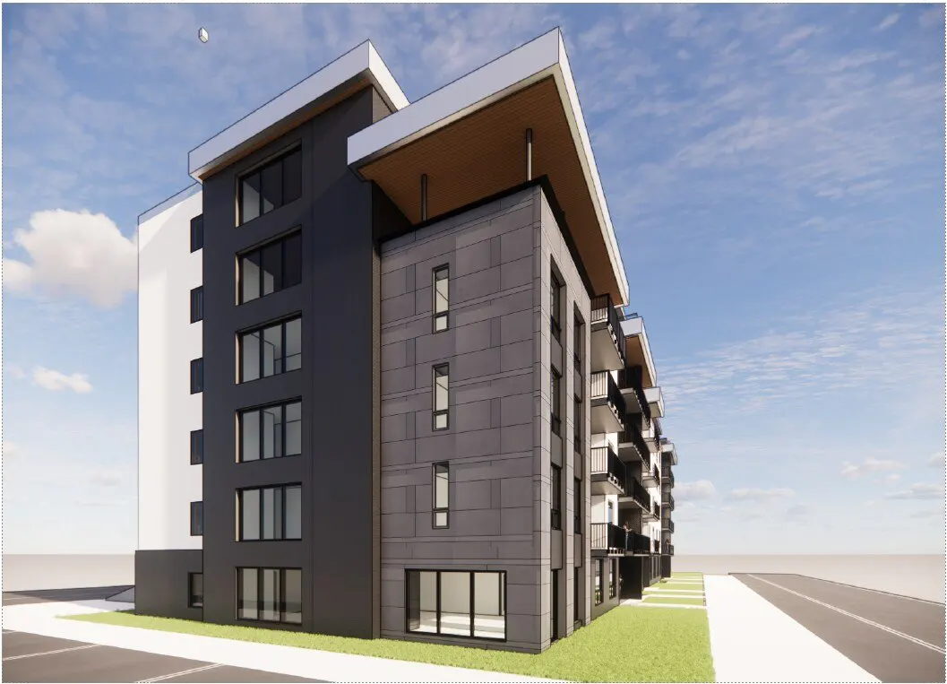 Modern multi-story apartment building with gray and white exterior, balconies, and large windows under a blue sky.