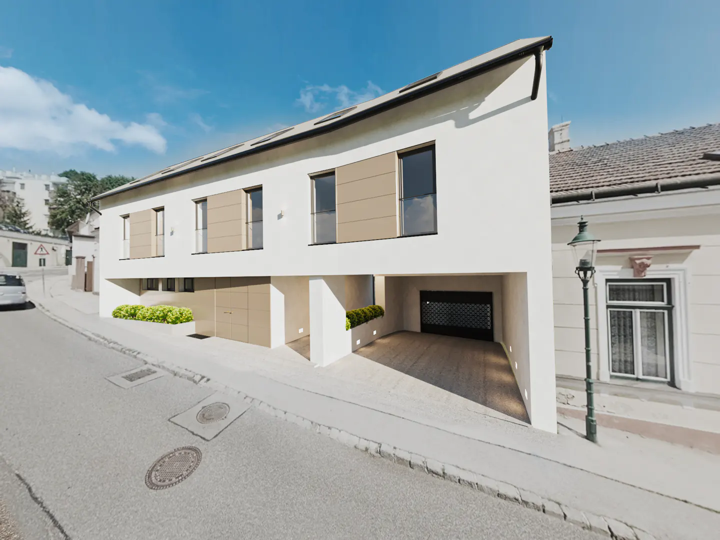 Modern white townhouse with tan accents and built-in garages on a sloping street under a blue sky.