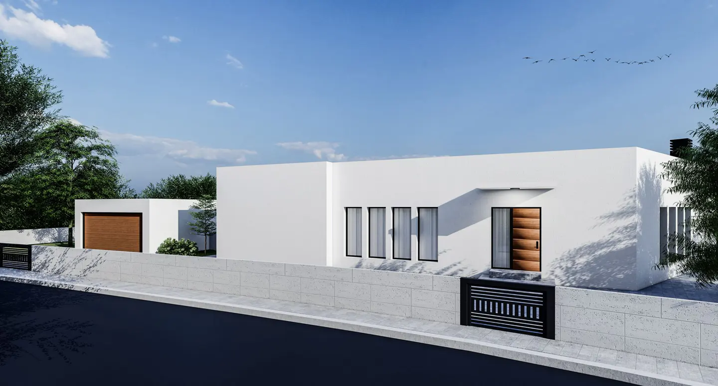 Modern white house with a wooden door and black window frames, surrounded by a stone wall and green trees.