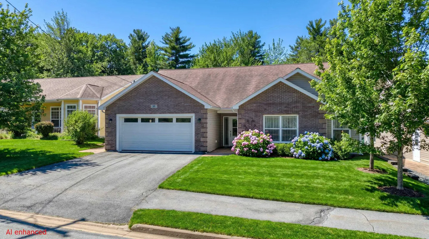A single-story brick house with a white garage door, green lawn, and pink and blue hydrangeas.