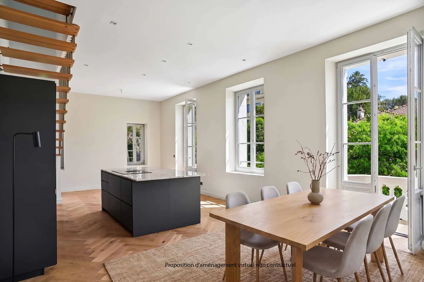 Bright, modern kitchen and dining area with herringbone wood floors, black island, and light wood table with six chairs. Large windows overlook lush greenery.