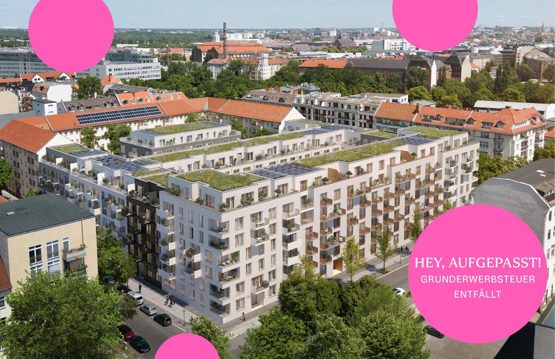 Aerial view of a modern white apartment complex with green roofs and balconies, surrounded by city buildings and trees. [AI-generated text]