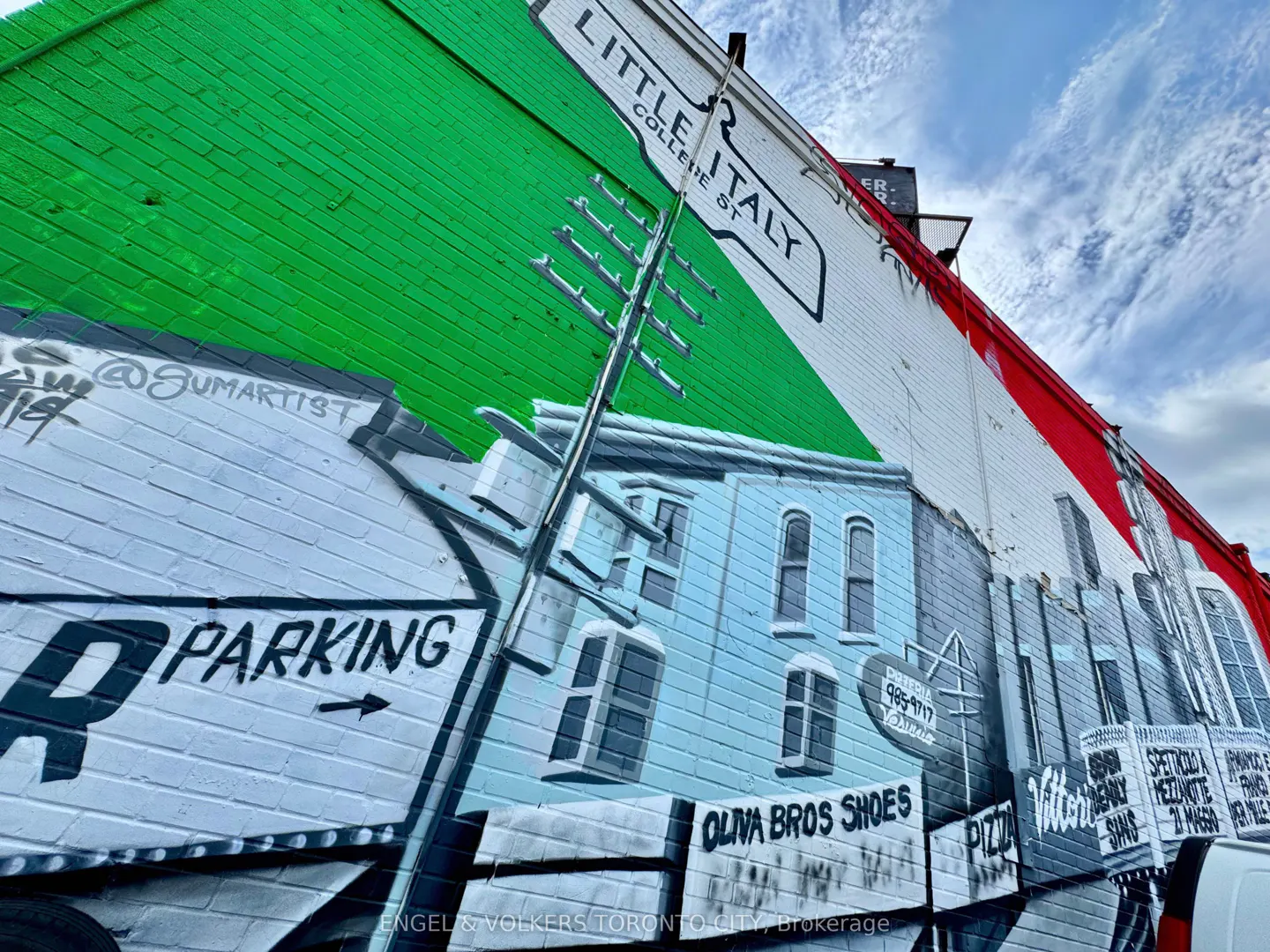 Mural on a brick building in Little Italy, Toronto, painted with the Italian flag colors and local business names.