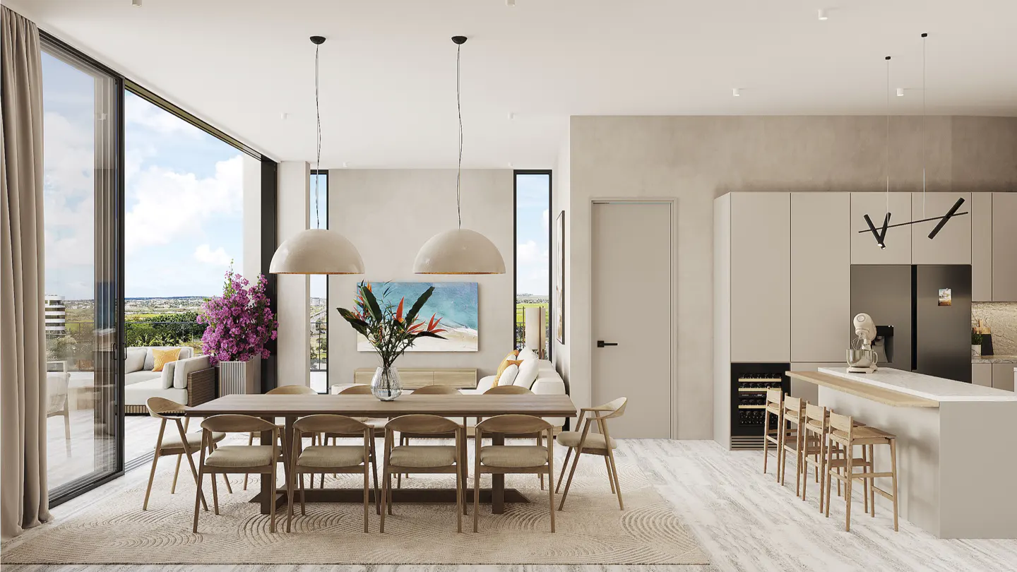 Open-concept living space with a dining table, chairs, and a kitchen island. Large windows offer a view of the outdoors.