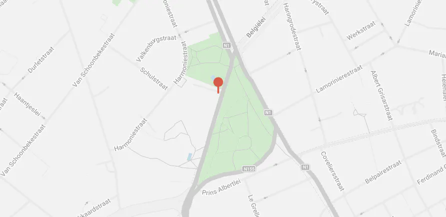 Map view of Harmoniepark in Antwerp, Belgium, with a red pin marker. Roads and streets surround the green park area.