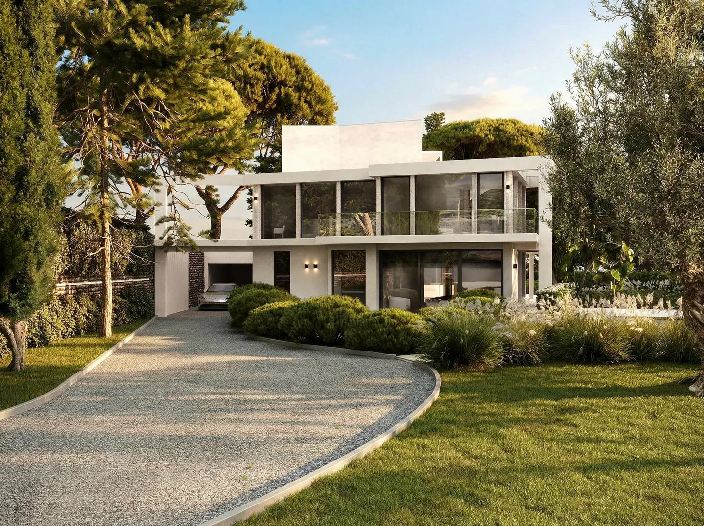 Modern white two-story house with large windows and a gravel driveway, surrounded by green trees and bushes.