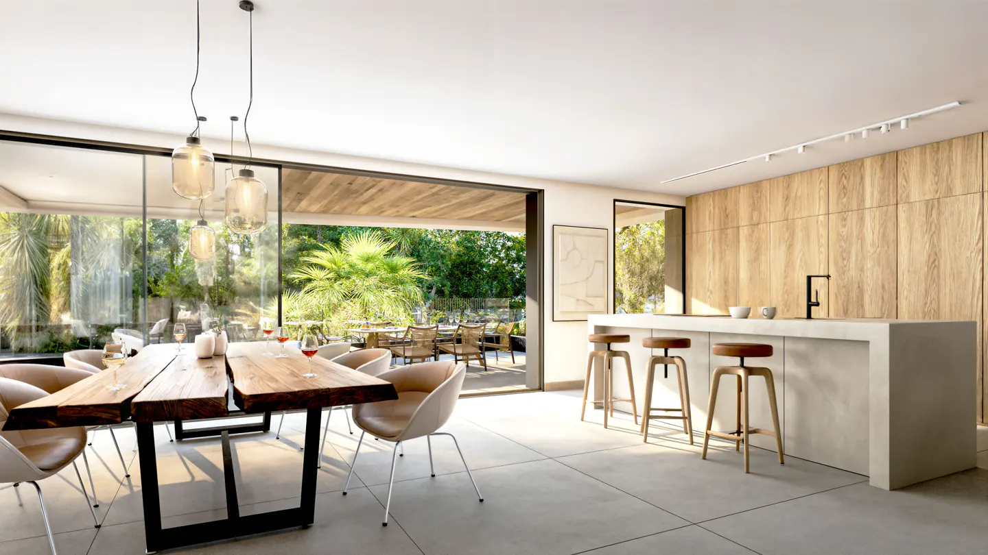 Open-concept kitchen and dining area with a wood table, island with stools, and sliding glass doors to a patio.