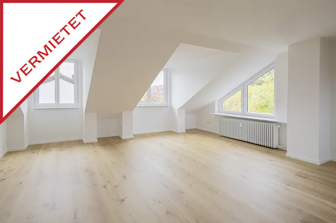 Bright, empty attic room with wood floors, white walls, and three windows. A red "VERMIETET" banner is in the top left corner.