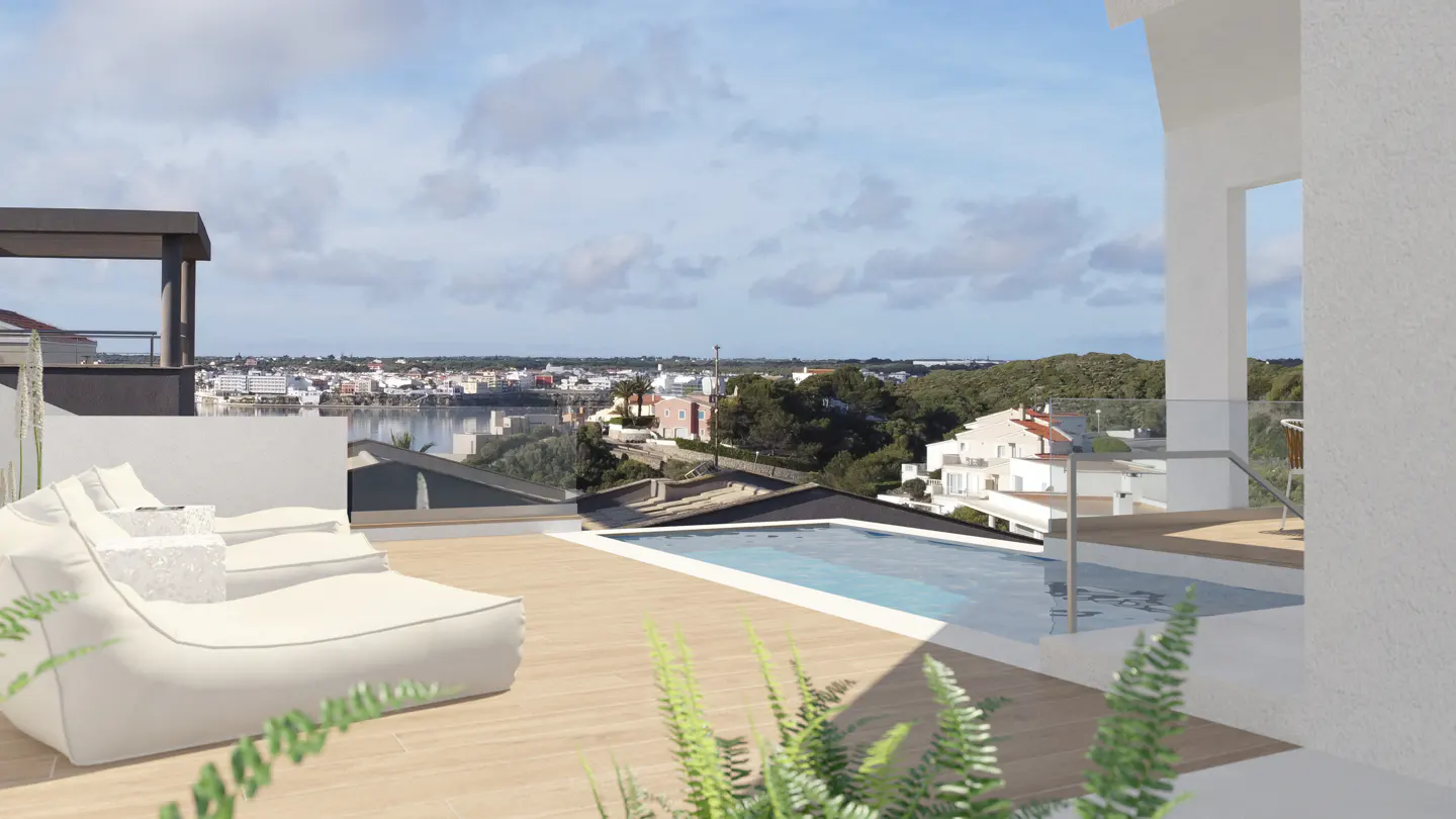 Rooftop terrace with a pool, white lounge chairs, and a view of a town and the sea under a cloudy sky.