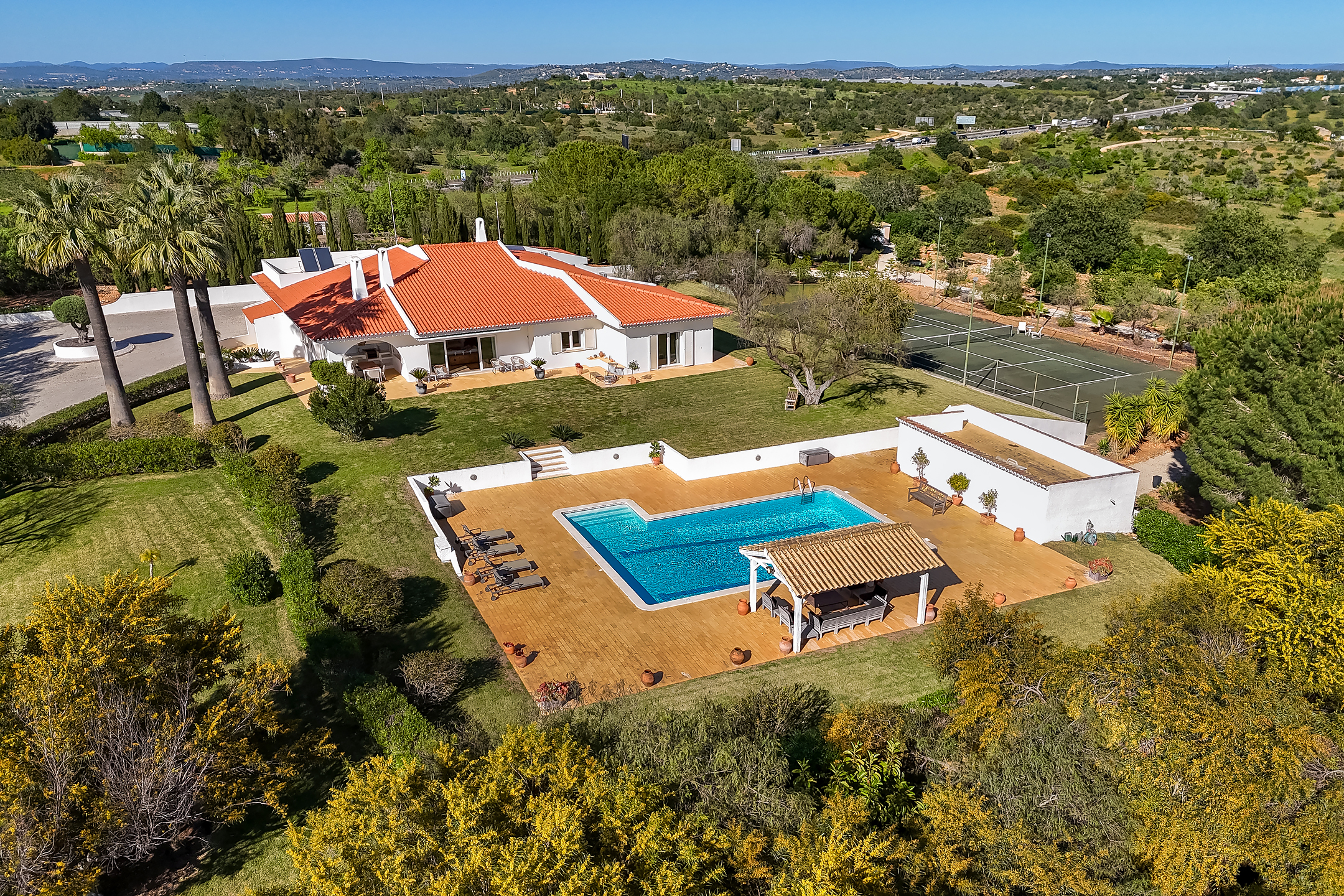 Prestigious villa with swimming pool, annex, and tennis court set in the heart of a landscaped garden