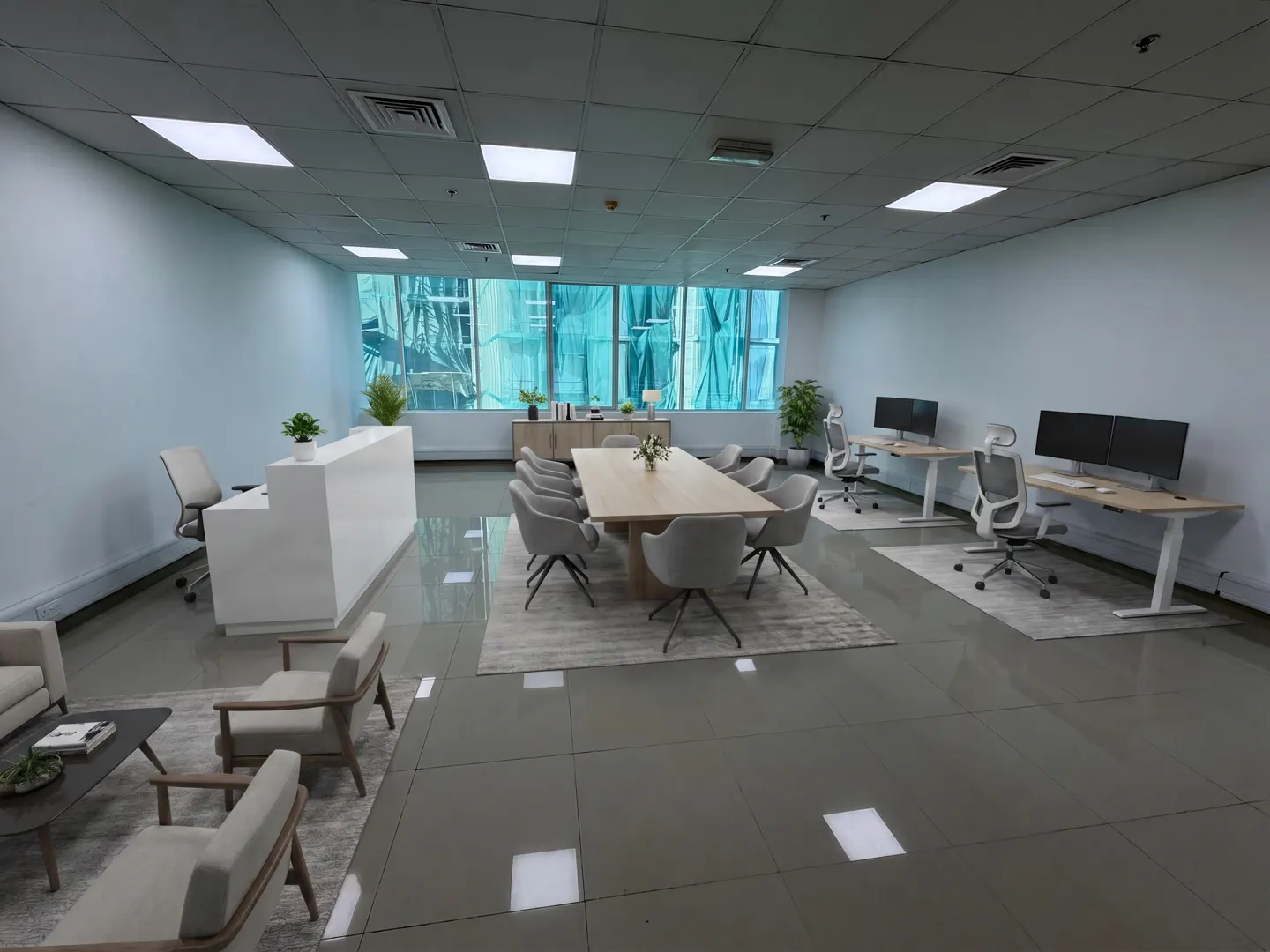 Bright, modern office space with a reception desk, conference table, and individual workstations. Neutral colors and clean lines create a professional atmosphere.