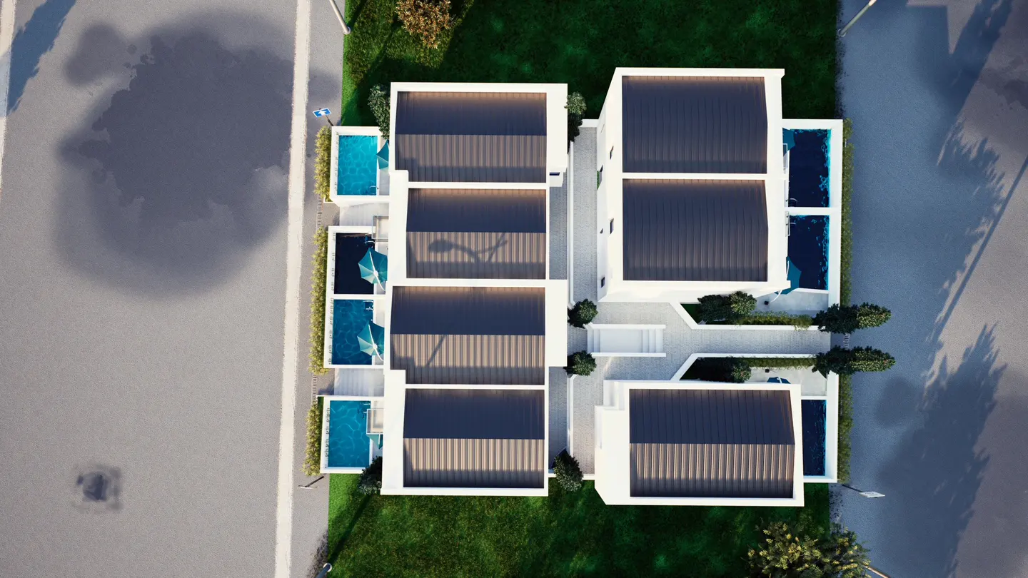 Aerial view of modern white townhouses with dark roofs, each with a private blue pool, surrounded by green lawns and a gray street.