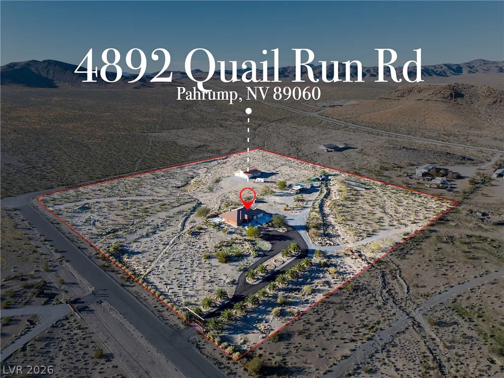 Aerial view of a desert property at 4892 Quail Run Rd, Pahrump, NV. The land is outlined in red, with a house, driveway, and desert landscape.