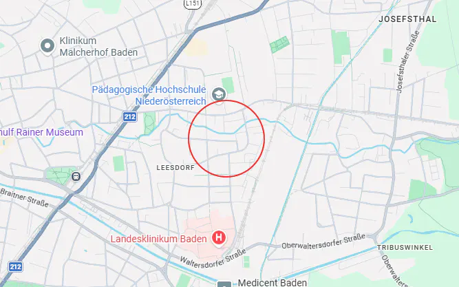 Map view of Leesdorf, Austria, with a red circle highlighting an area near a blue river. Roads and landmarks are labeled.