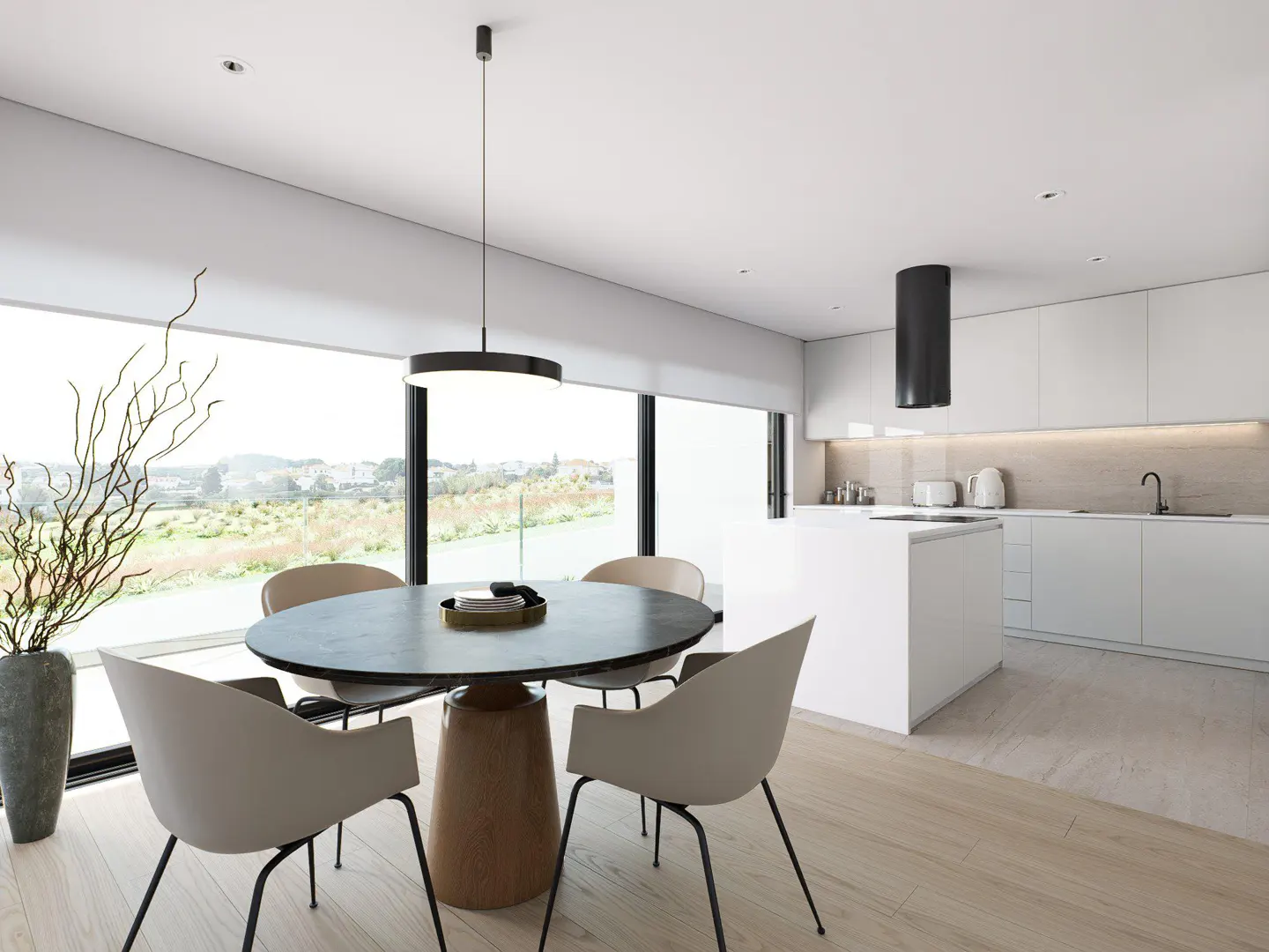 Bright, modern kitchen with a round black table, tan chairs, and a large window overlooking a green landscape. White cabinets and island complete the space.