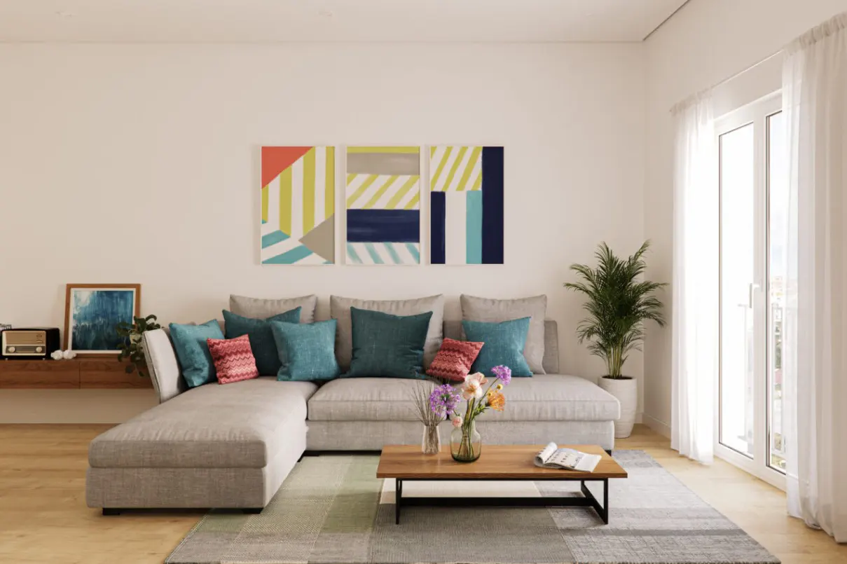 Modern living room with a grey sectional sofa, colorful accent pillows, a wooden coffee table, and abstract wall art.