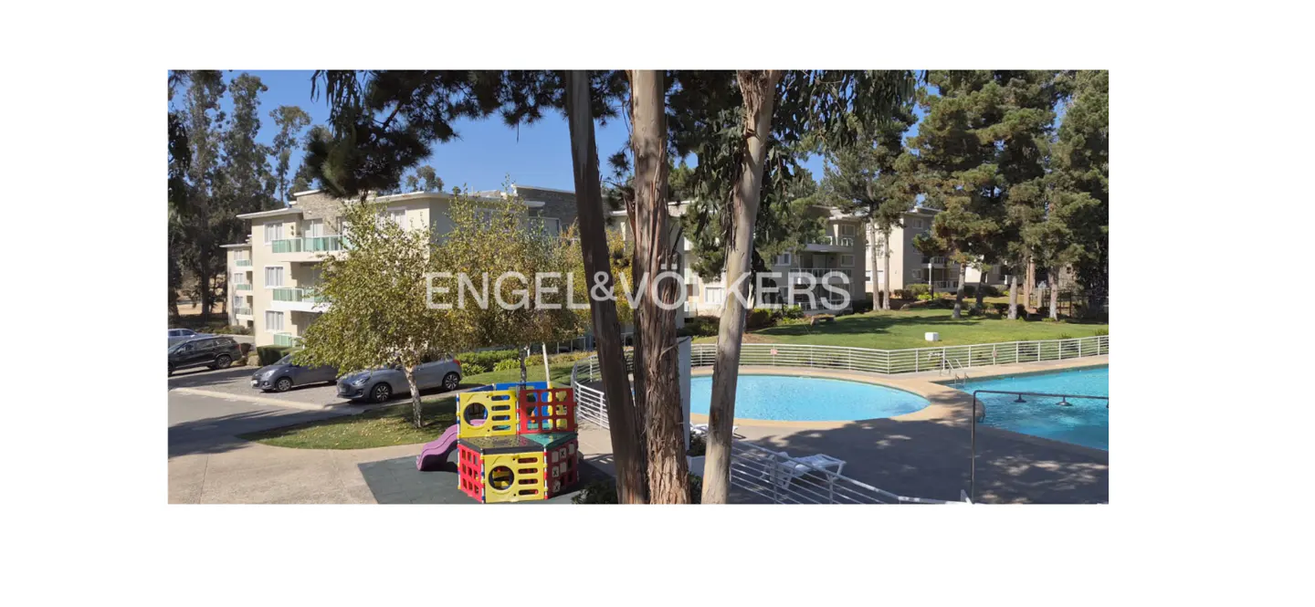 Apartment complex with a pool, playground, and parking. Trees surround the property. Engel & Volkers logo is visible.