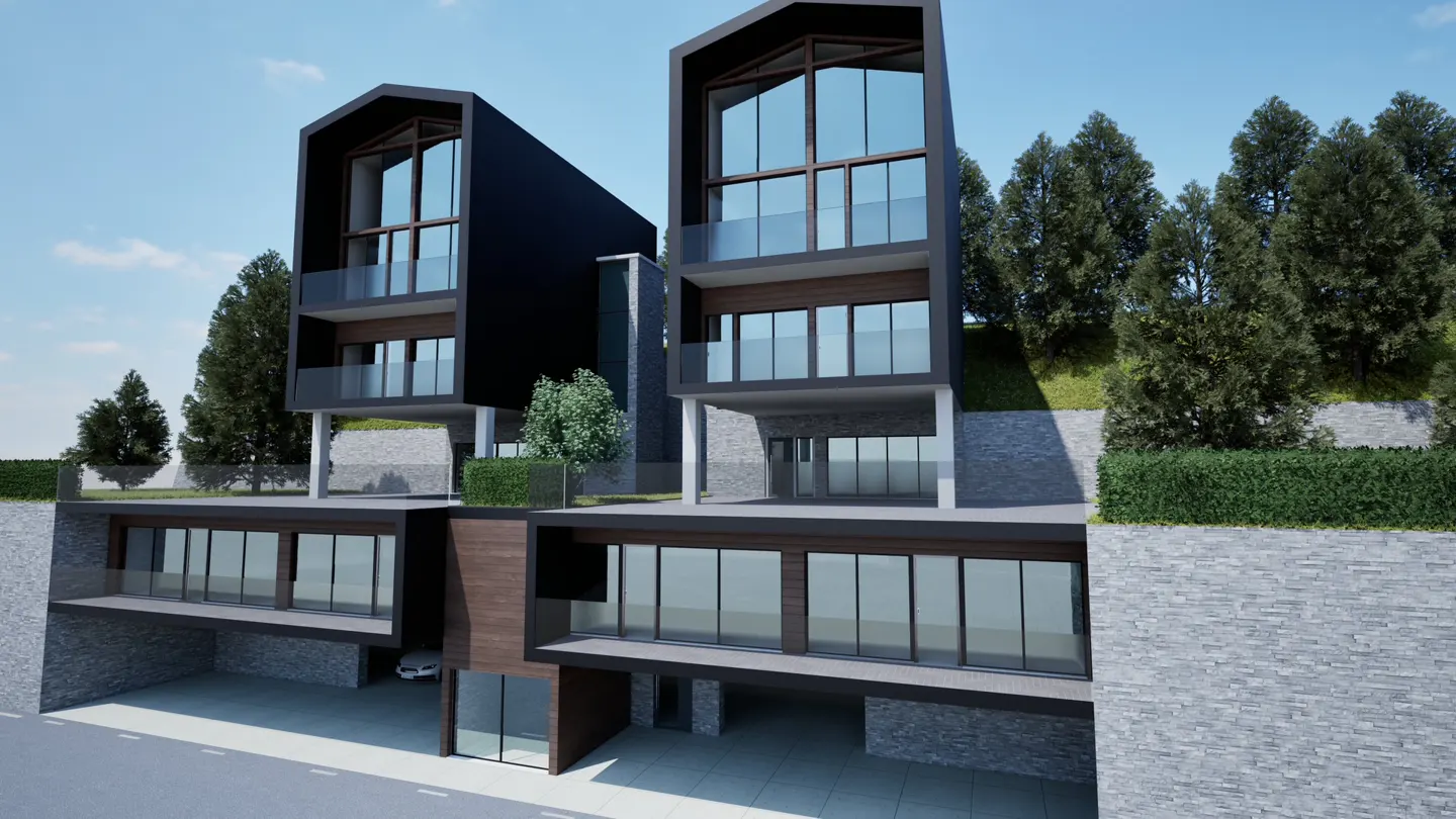 Modern two-story black and brown homes with large windows and glass balconies. Trees and blue sky in the background.