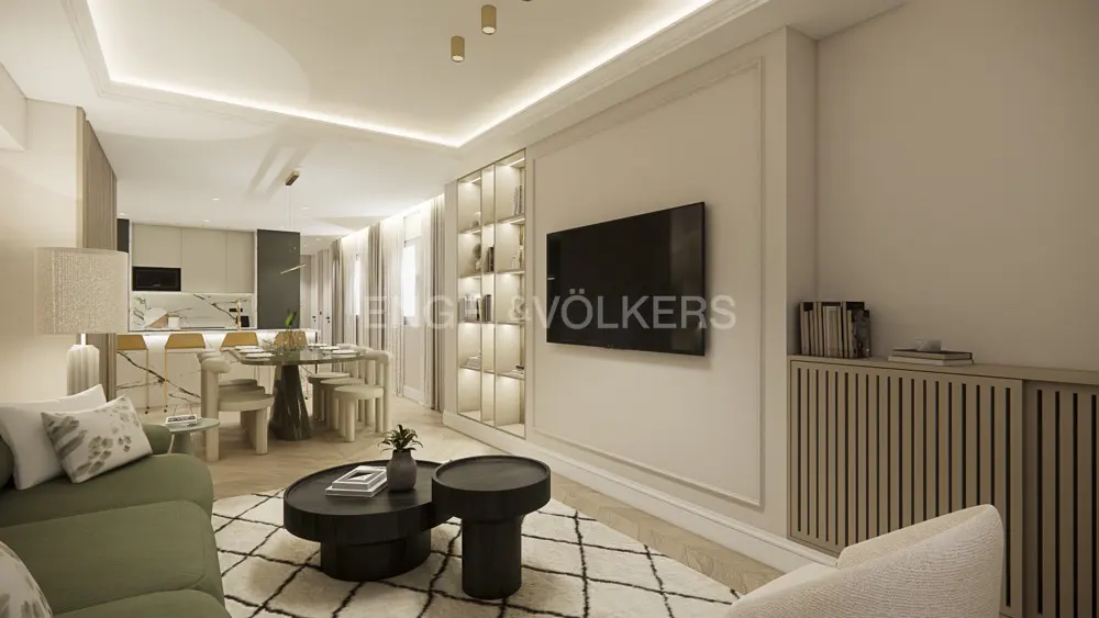 Modern open-plan living room with a green sofa, black coffee tables, wall-mounted TV, and a dining area in the background.