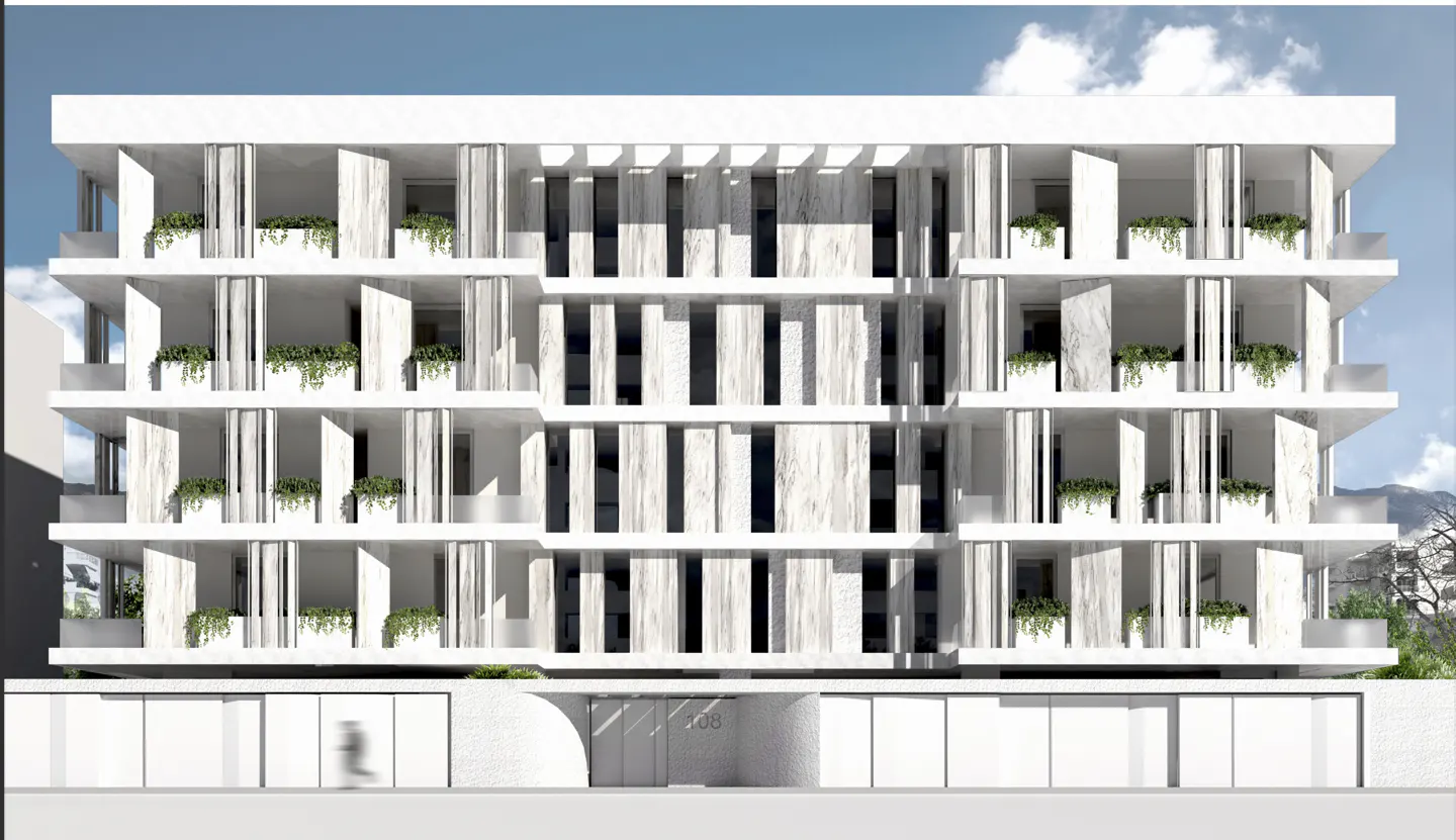Facade of a modern, white, multi-story apartment building with balconies and greenery.