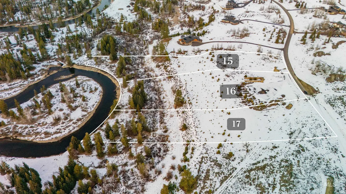 Aerial view of snowy land plots 15, 16, and 17, bordered by a river and trees. Houses are visible in the background.