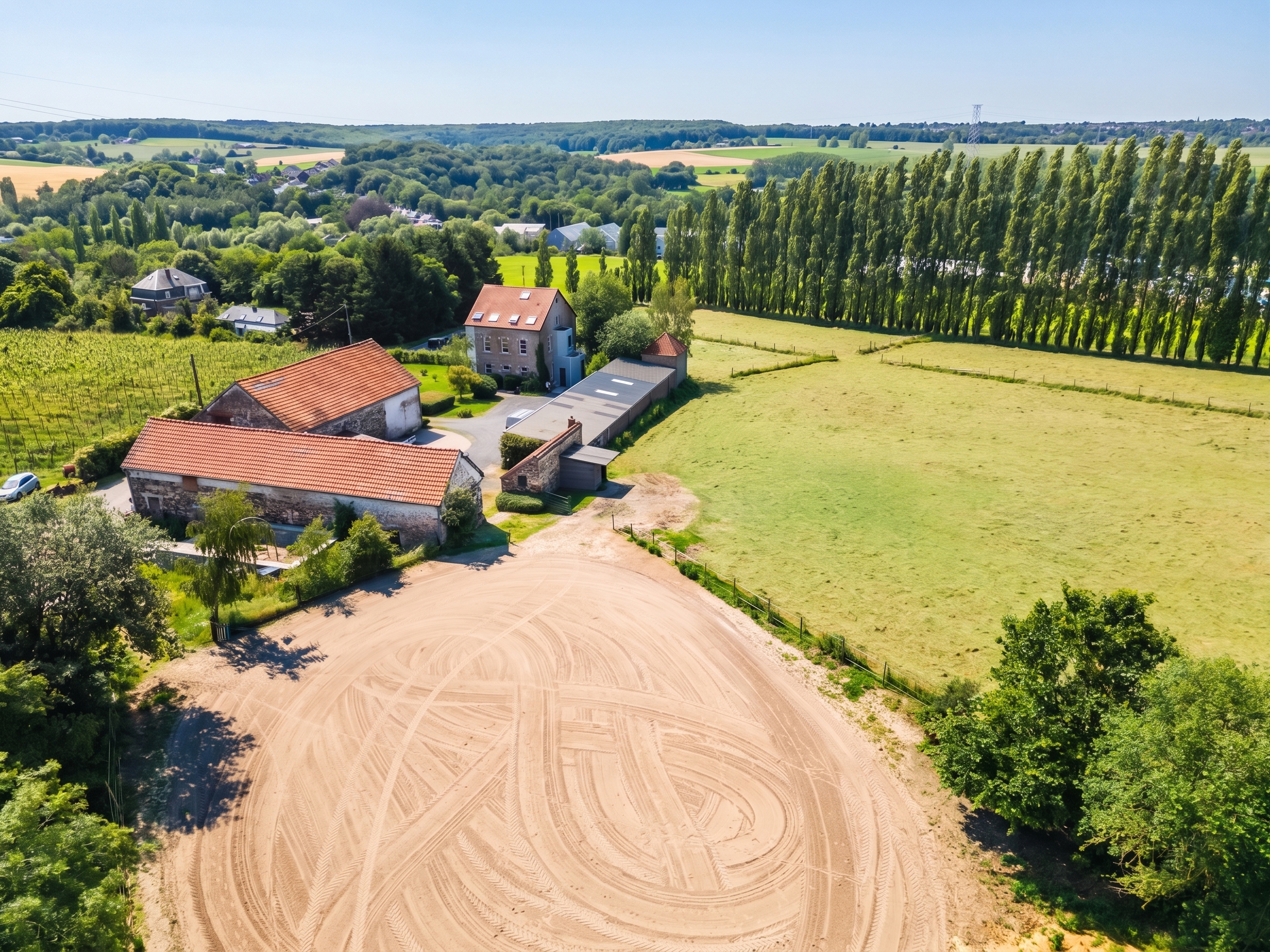 Equestrian property with riding arena and stables surrounded by open fields [AI-modified]