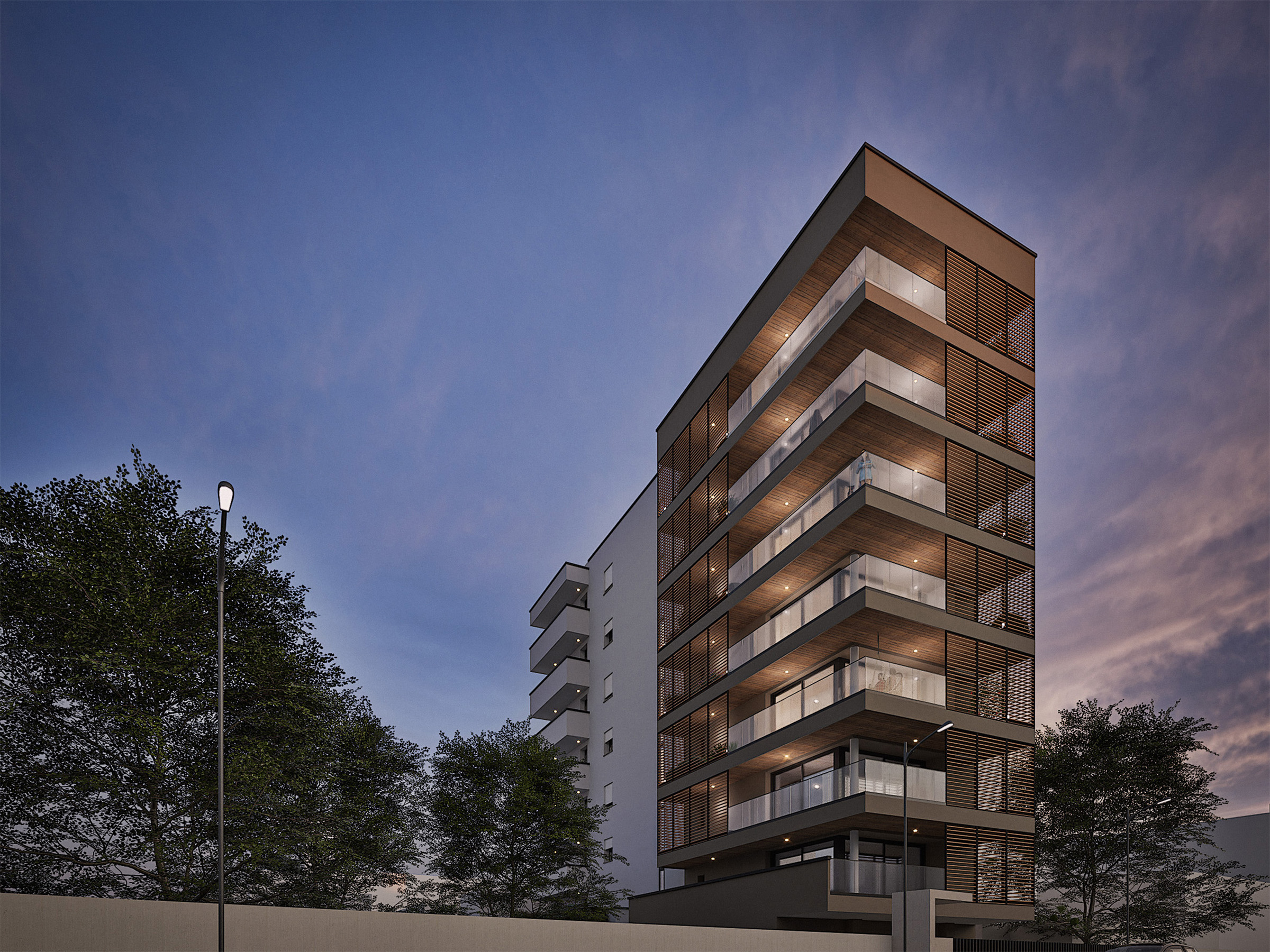 Modern apartment building with illuminated balconies and wooden privacy screens at twilight against a blue sky.