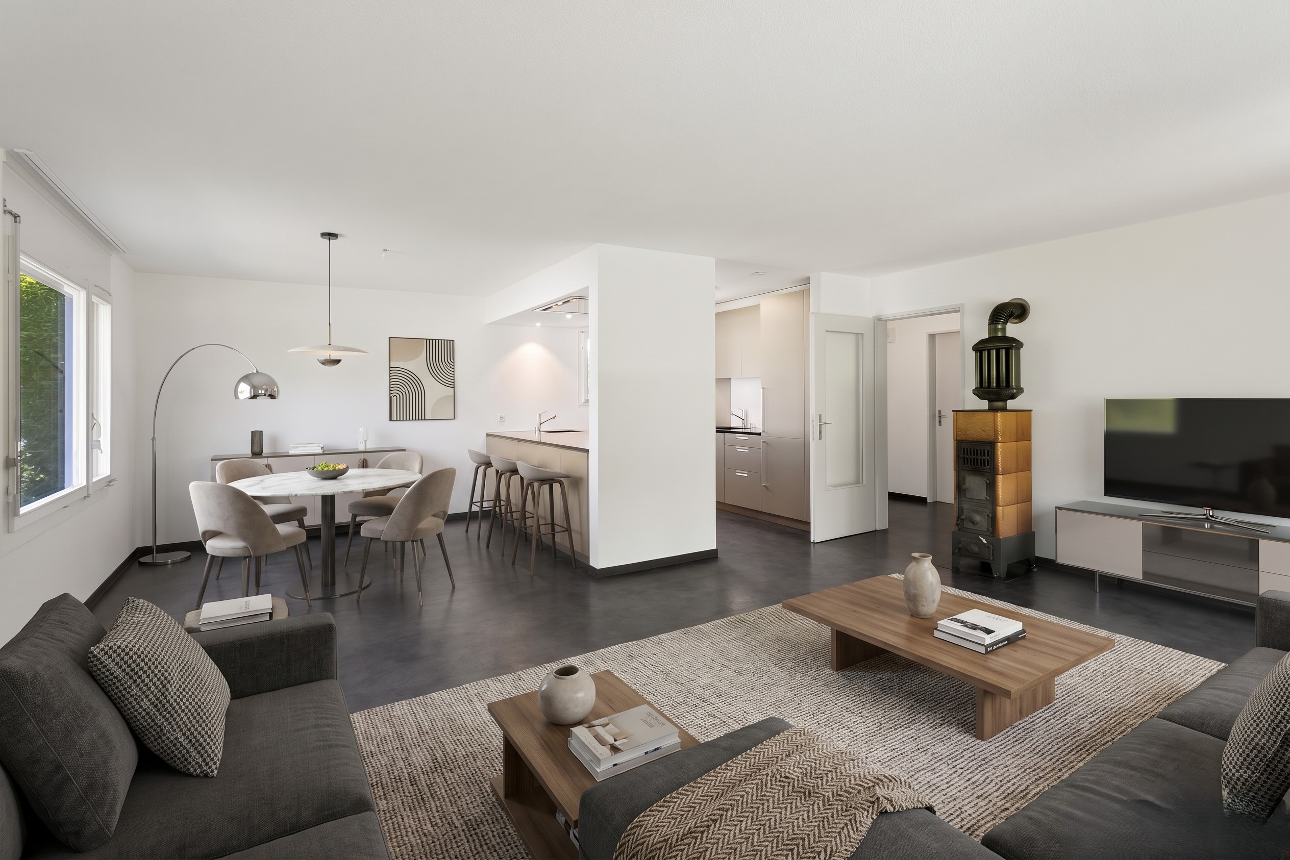 Modern open-plan living area with grey sofas, wooden coffee tables, dining set, and a unique wood-burning stove. [AI-generated text]