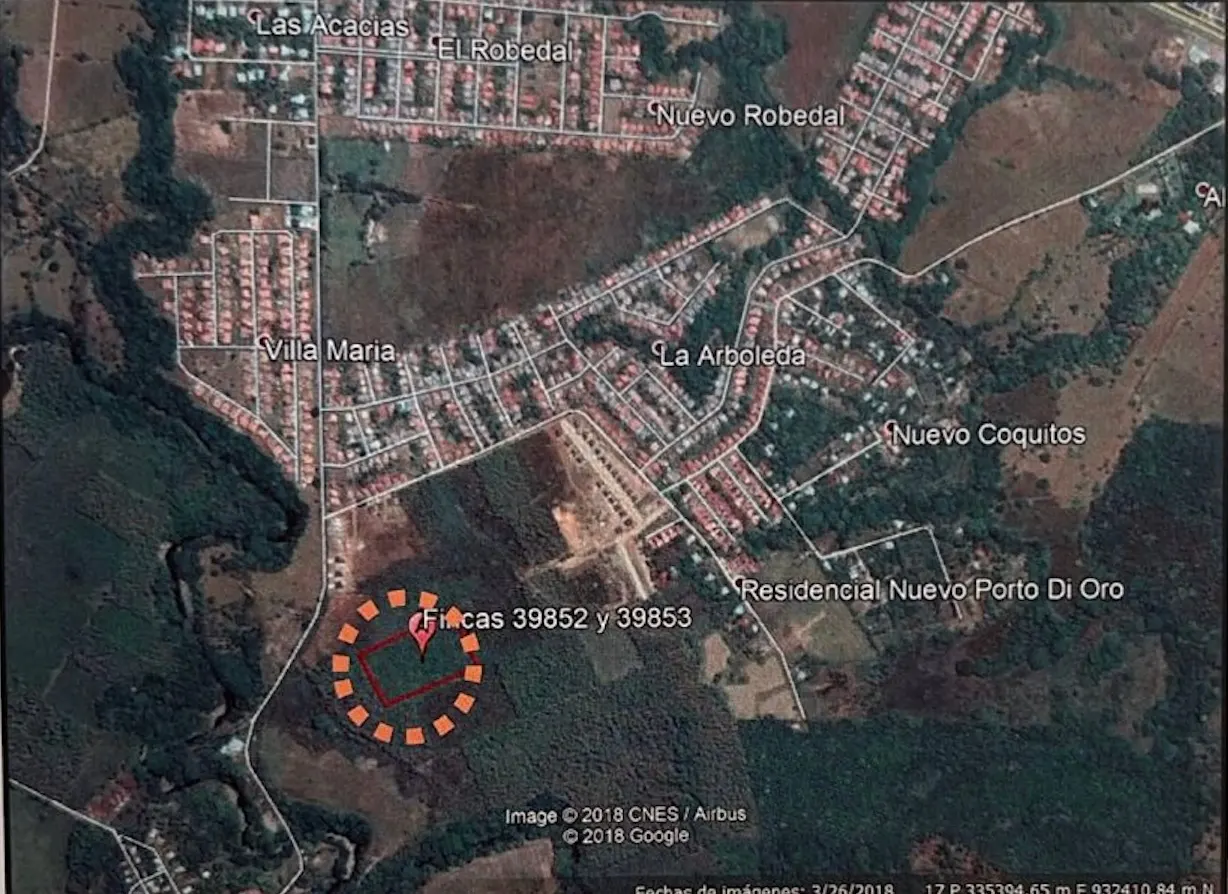Aerial view of land parcels 39852 & 39853, surrounded by a dotted orange circle, near residential areas and green spaces.