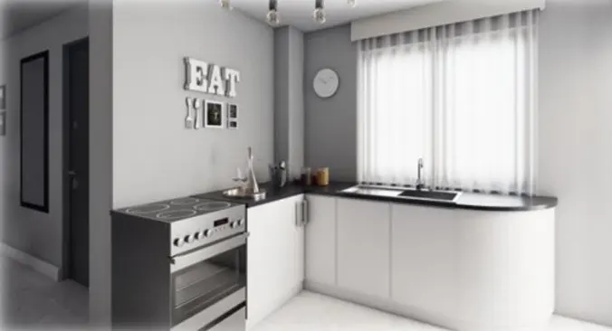 A modern kitchen with white cabinets, a black countertop, and stainless steel appliances. A window with sheer curtains provides natural light. "EAT" decorates the gray wall.