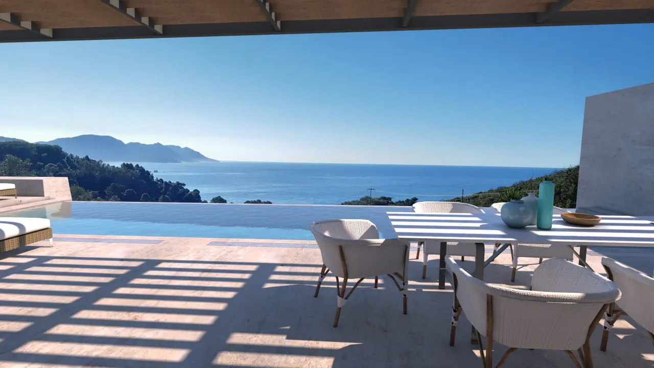 Outdoor patio with white table and chairs overlooking an infinity pool and ocean view.
