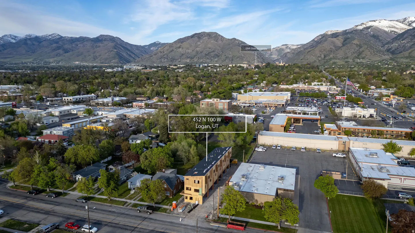 Aerial view of 452 N 100 W, Logan, UT, with mountains in the background. A new building is under construction.