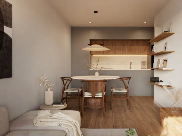 A bright, modern apartment interior with a round dining table, wooden chairs, and open kitchen. Shelves with decor add a personal touch.