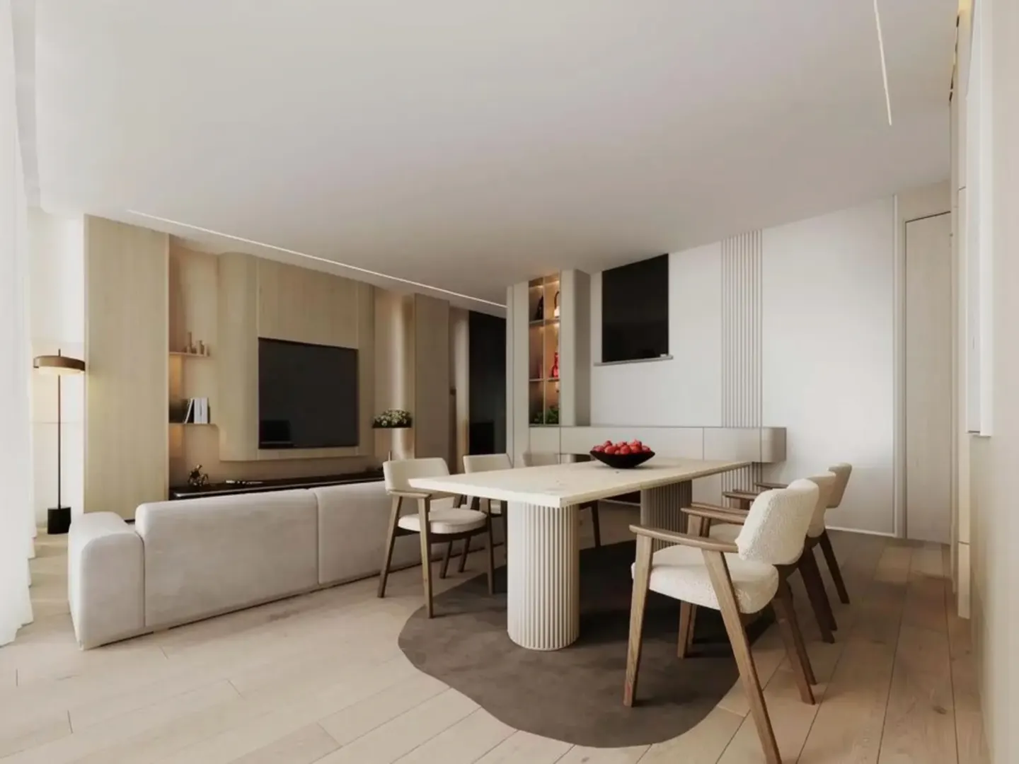 A modern living and dining area with a beige sofa, a light wood dining table with a bowl of red apples, and wooden chairs.