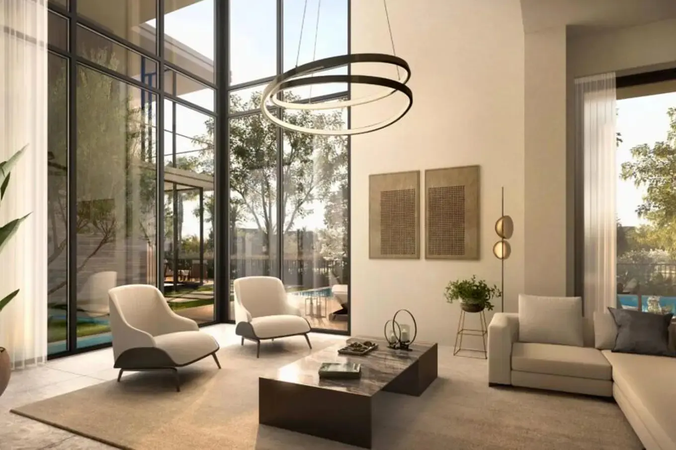 Bright living room with floor-to-ceiling windows, two cream chairs, a marble coffee table, and a modern circular chandelier.