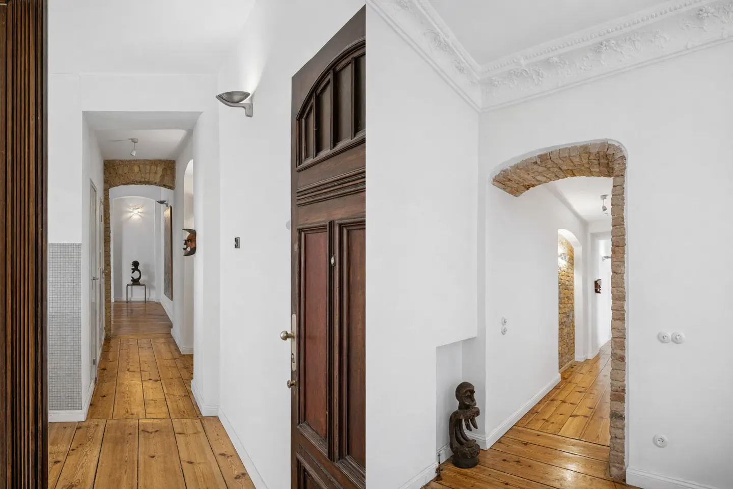 Hallway collage with hardwood floors, white walls, and brick archways. A dark wood door is on the right.