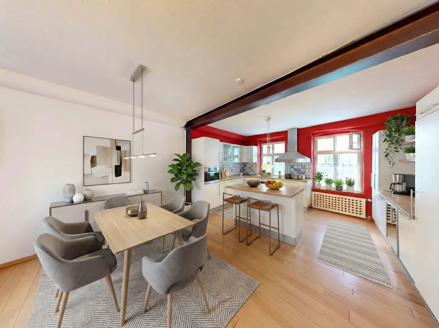 Open-concept dining and kitchen area with light wood floors, gray chairs, and red accent walls.