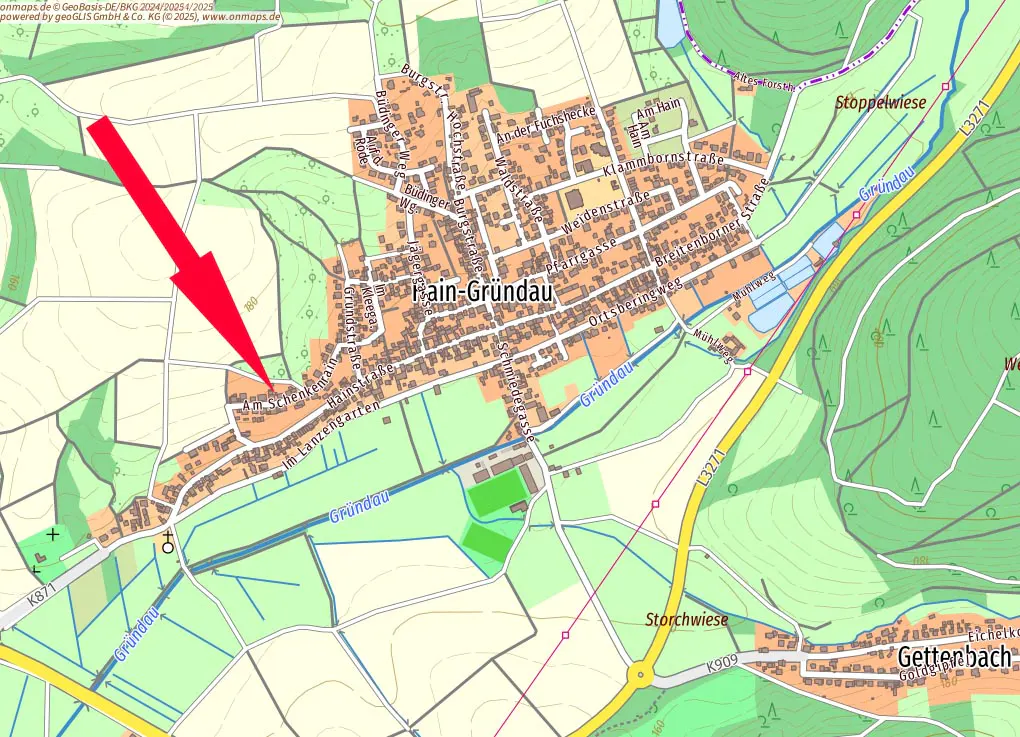 Map of Hain-Gründau, Germany, with a red arrow pointing to Am Schenkengarten street. Roads, buildings, and green fields are visible.