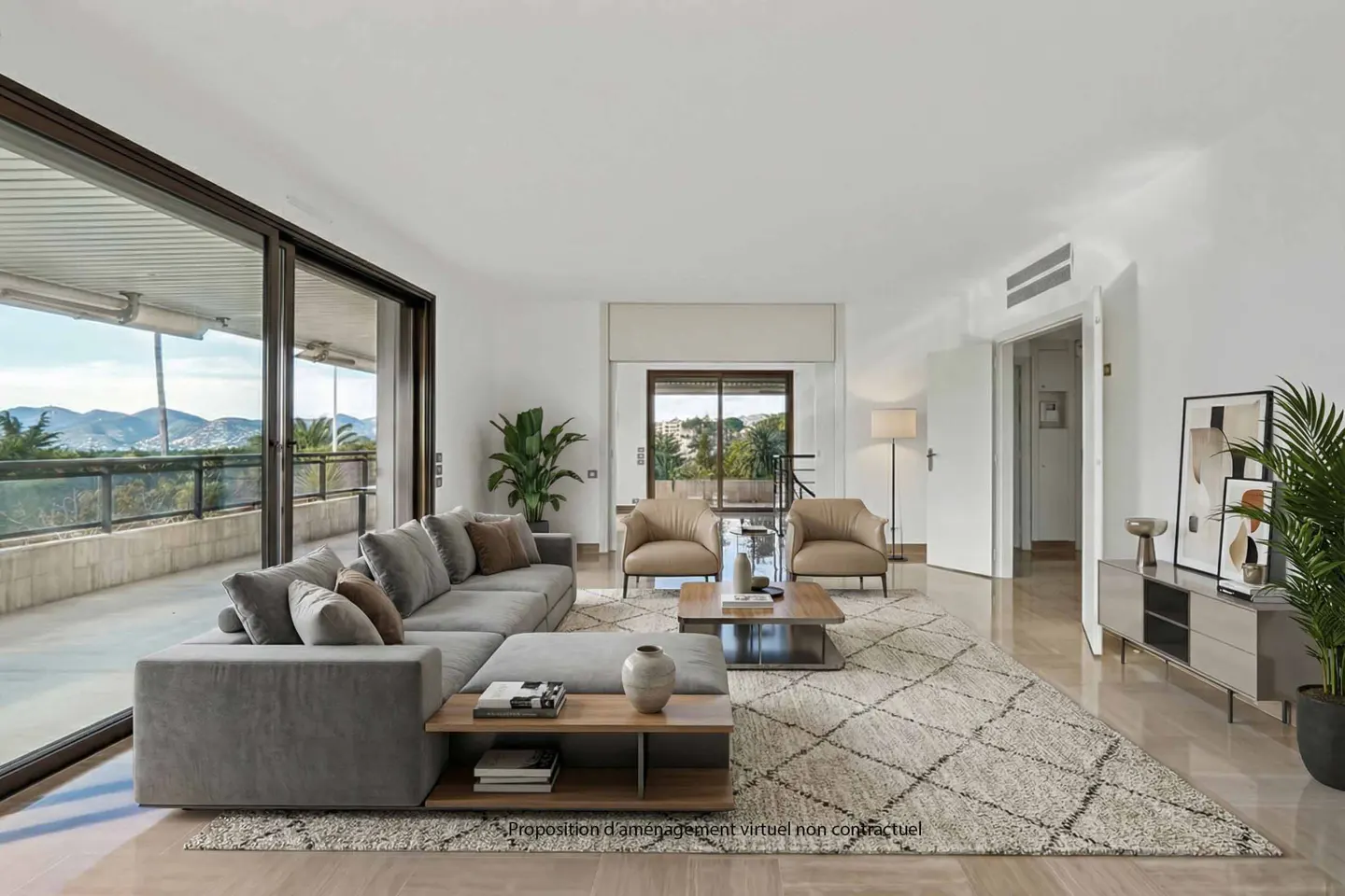 Bright living room with a gray sectional sofa, two tan armchairs, and a patterned rug. Balcony with a view is visible.