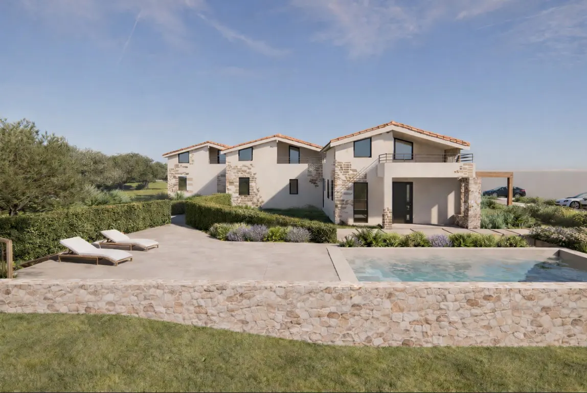 Three modern, two-story homes with red tile roofs, stone accents, and a pool, surrounded by green landscaping under a blue sky.