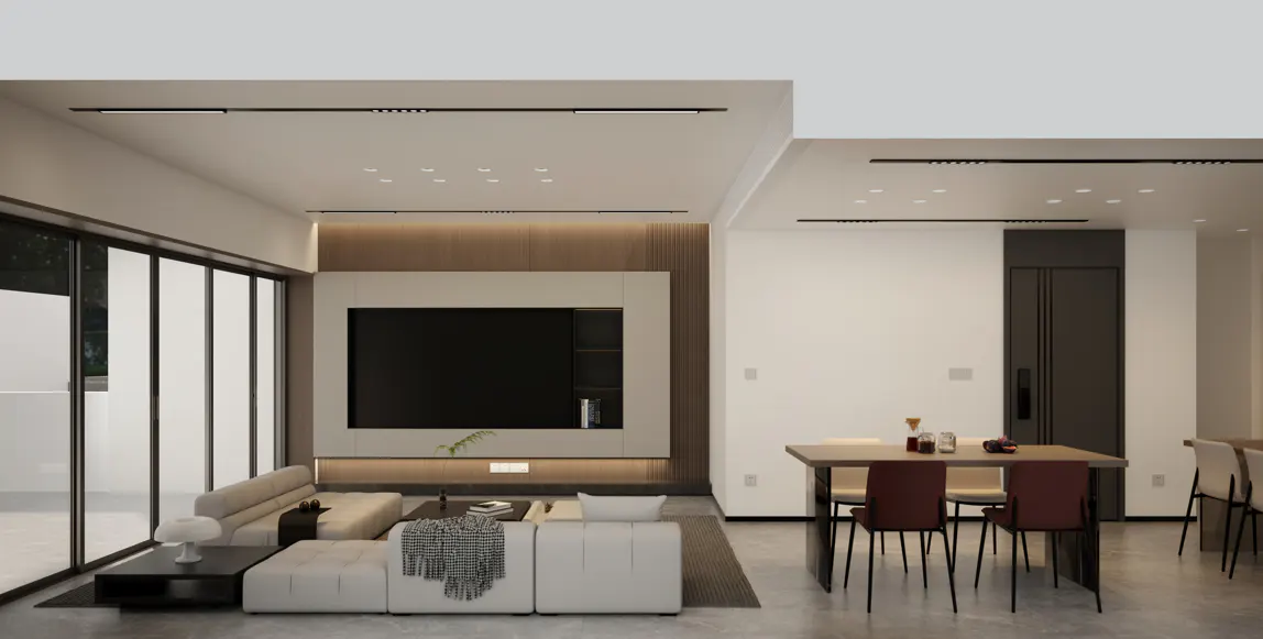 A modern living room with a white sectional sofa, a large TV, and a dining table with red chairs.